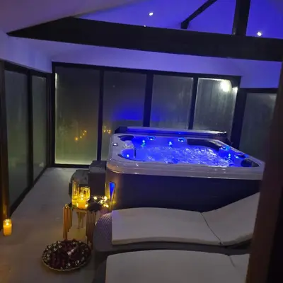 a room with a hot tub on a balcony at night at Casa Veneta in Oreshak