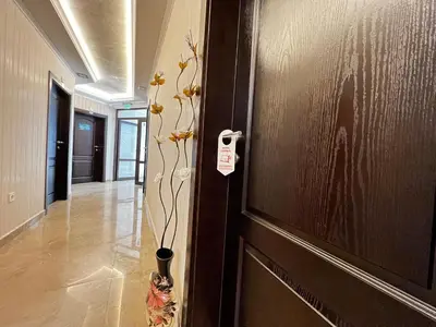 a door with a vase with flowers in a hallway at Hotel Central in Karlovo
