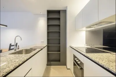 a kitchen with white counters and a sink and a stove at City Apartments - Mall of Sofia & Metro Station in Sofia