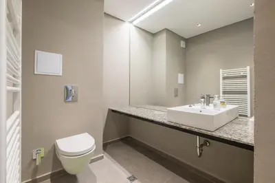a bathroom with a white sink and a toilet at City Apartments - Mall of Sofia & Metro Station in Sofia