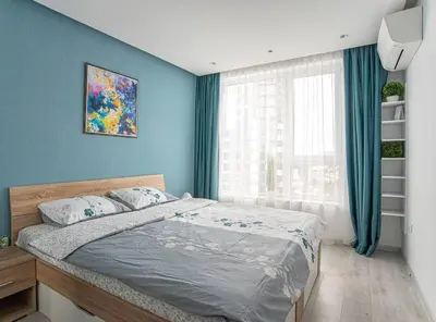 a bedroom with a bed with blue walls and a window at Sunny & Stylish Brand new 2bdr Apartment + Parking in Sofia