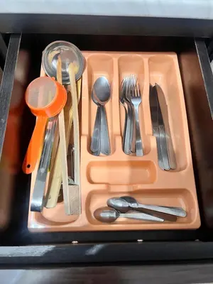 an orange tray with utensils in a drawer at St. Anastasia Apartments in Bansko