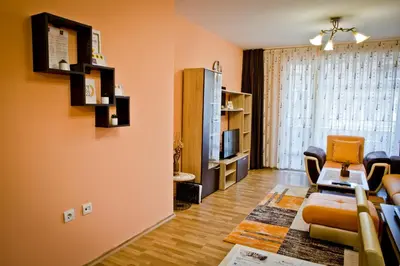 a living room with a couch and a table at Sunflower Apartment City Center in Plovdiv