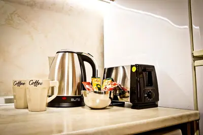 a kitchen counter with a coffee maker and a coffee cup at Sunflower Apartment City Center in Plovdiv