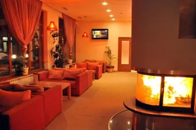 a living room with couches and a fire place at Studio Villa Park 410 in Borovets