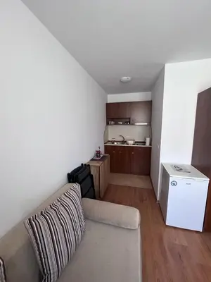 a living room with a couch and a kitchen at Kalina Apartment's in Bansko in Bansko