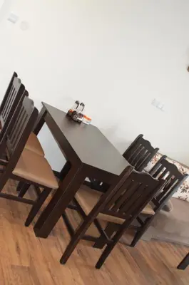 a dining table and chairs sitting on a wooden floor at Grand Bansko D104 APARTMENT in Bansko