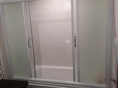 a shower with a glass door in a bathroom at Grand Bansko D104 APARTMENT in Bansko