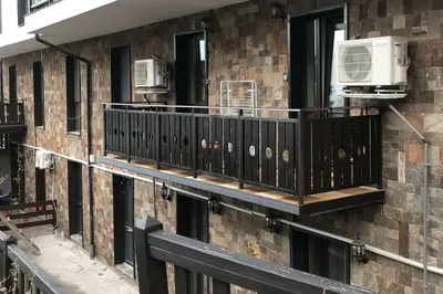 a balcony on the side of a building with a air conditioner at Grand Bansko D104 APARTMENT in Bansko