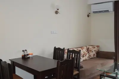 a living room with a table and a couch at Grand Bansko D104 APARTMENT in Bansko