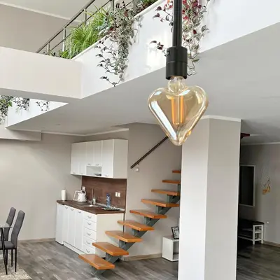 a staircase in a living room with a kitchen at ATRIUM Boutique Suites Sofia in Sofia