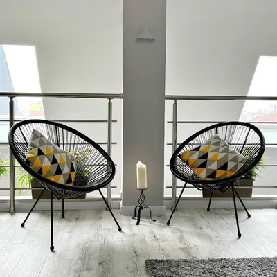 two chairs with pillows sitting in a room at ATRIUM Boutique Suites Sofia in Sofia