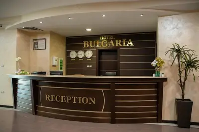 a hotel reception counter in a lobby with a sign at Хотел България Петрич in Petrich