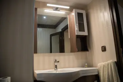 a bathroom with a sink and a mirror at Хотел България Петрич in Petrich