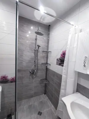 a bathroom with a shower and a toilet and a sink at Mountain view apartment in Sofia