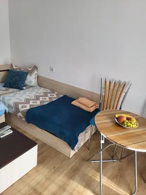 a room with a bed and a table with a bowl of fruit at THE CENTER Apartments Comfort in Sandanski