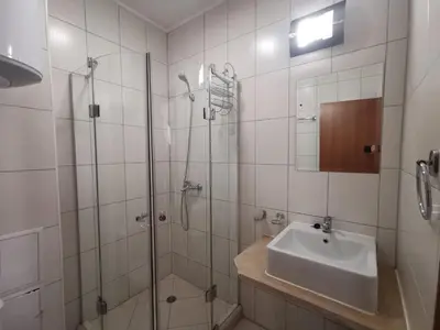 a bathroom with a glass shower and a sink at Sunny home by the lift in Bansko in Bansko