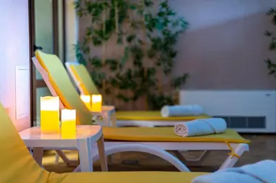 a room with two chairs and a table with lights at Skyday Penthouse Deluxe at Oak Residence in Smolyan