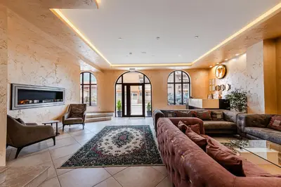 a large living room with couches and a tv at Ardo Spa Hotel and Restaurant in Sarnitsa