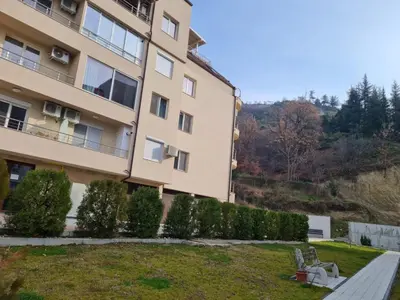 a building with a bench in front of it at Riverpark Holiday Apartment, Sandanski in Sandanski