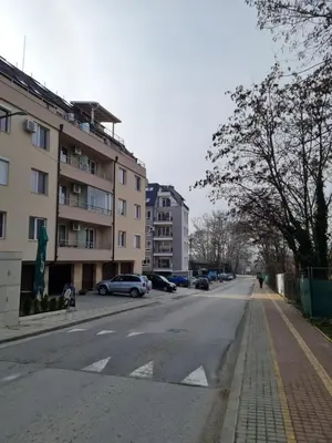 an empty street with cars parked on the side of a building at Riverpark Holiday Apartment, Sandanski in Sandanski