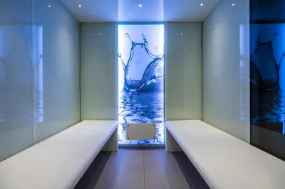 an empty room with blue walls and a glass door at VIZUALIZA Residence Hotel by HMG in Plovdiv