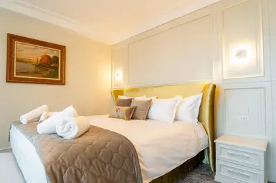 a hotel room with a bed with white pillows at VIZUALIZA Residence Hotel by HMG in Plovdiv