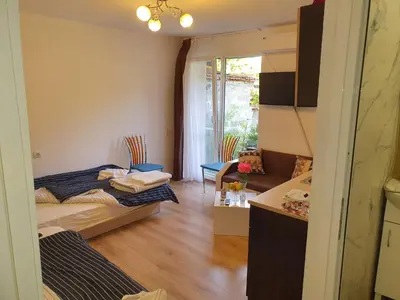 a room with two beds and a living room at THE CENTER Apartments Comfort 3 in Sandanski
