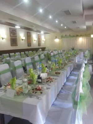 a banquet hall with white tables and chairs with plates of food at Winslow Infinity Aparthotel in Bansko