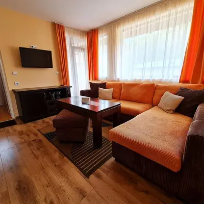a living room with a couch and a table at Family Hotel Chiflik Hills in Chiflik