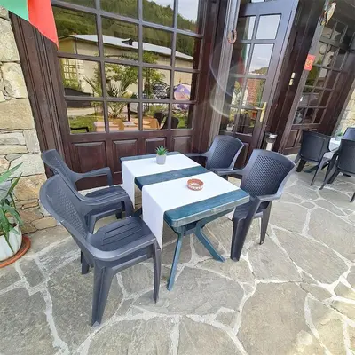 a table and chairs sitting on a patio at Family Hotel Chiflik Hills in Chiflik