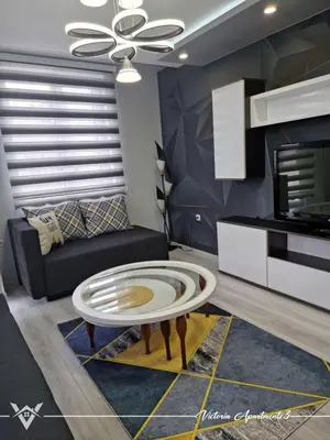 a living room with a couch and a table at Victoria apartments 3 in Velingrad