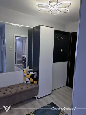 a living room with a couch and a mirror at Victoria apartments 3 in Velingrad