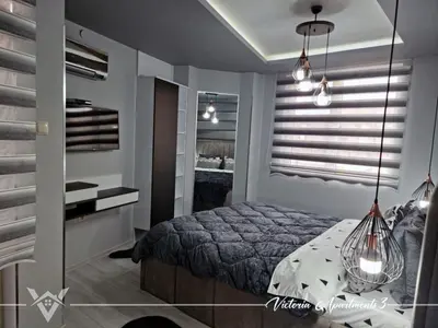 a bedroom with a bed and a mirror at Victoria apartments 3 in Velingrad