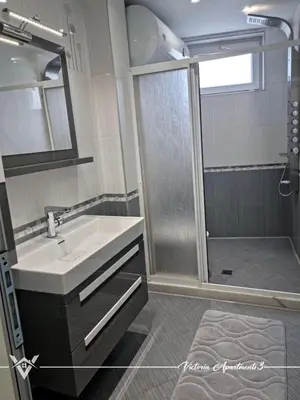 a bathroom with a sink and a shower at Victoria apartments 3 in Velingrad