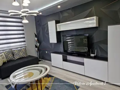 a living room with a tv and a couch at Victoria apartments 3 in Velingrad