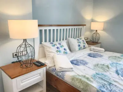 a bedroom with a bed and two lamps on a nightstand at Charming Apartment Sofia 100m² in Sofia