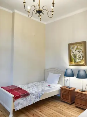 a bedroom with a bed and two night stands at Charming Apartment Sofia 100m² in Sofia