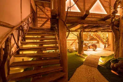 a wooden staircase in a room with green grass at Tihiat Kut Complex in Kyustendil