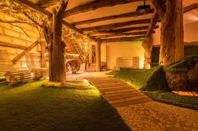 a garden with a tree and a stone walkway at Tihiat Kut Complex in Kyustendil