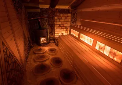 an inside view of a sauna with a stove at Tihiat Kut Complex in Kyustendil
