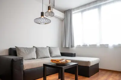 a living room with a couch and a table at Sunny 1BDR Apartment near Center in Sofia