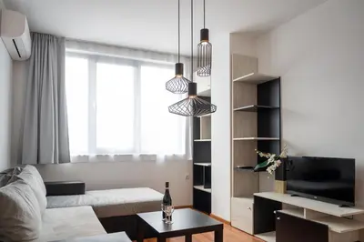 a living room with a couch and a tv at Sunny 1BDR Apartment near Center in Sofia