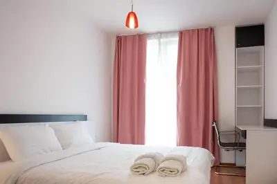 a bedroom with a bed with two slippers on it at Sunny 1BDR Apartment near Center in Sofia