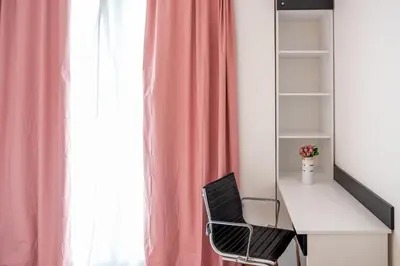 a desk with a chair next to a window at Sunny 1BDR Apartment near Center in Sofia