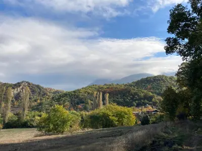 a view of the mountains from a field at Villa Rosa in Krayni Dol