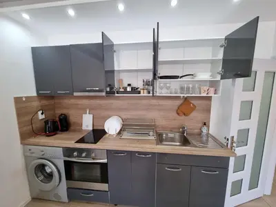 a kitchen with a sink and a washing machine at Luxury two bedroom Crown apartament in Botevgrad
