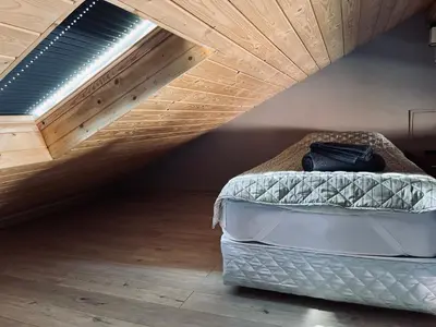 a bedroom with a bed with a wooden ceiling at Апартаменти за гости ,,Friends