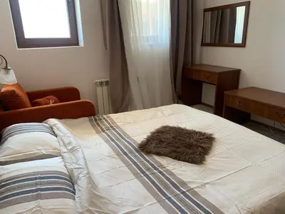 a bed with a furry pillow on top of it at Bansko Ski To Door Studio De Luxe in Bansko