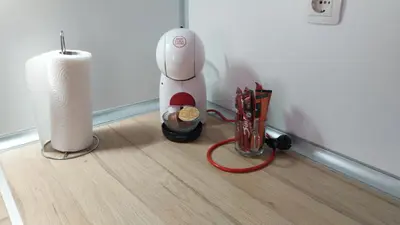 a hair dryer sitting on a floor next to a candle at Апартамент Лидия in Chepelare
